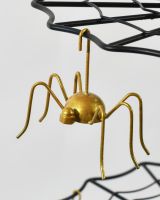 Close up of intricate spider detail on three tier cake stand