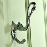 Bright Chrome Swan Coat Hook on a Green Surface