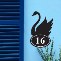 Iron Swan House Number Sign in Situ on a Blue Wall 