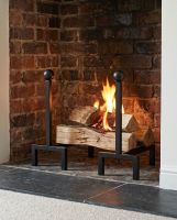 The Black Contemporary Steel Fire Dogs on a Stone Hearth next to a Traditional Fireplace - Digital Illustration