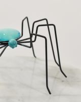 Close up of leg detail on colourful enamel spider sculpture