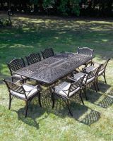 The "Highgrove" 8-Seater Luxury Garden Dining Set - Antique Copper In A Garden The "Highgrove" 8-Seater Luxury Garden Dining Set - Antique Copper In A Garden
