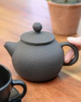 "Kage" Cast Iron Japanese Style Teapot in Charcoal with Hand in Shot for Scale "Kage" Cast Iron Japanese Style Teapot in Charcoal with Hand in Shot for Scale