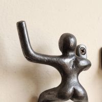 The 100mm Climbing Man Cast Antique Iron Coat Hook Pair Showing a Close up of the Hook - Digital Illustration