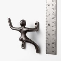 The 100mm Climbing Man Cast Antique Iron Coat Hook Pair Showing a Ruler Next to One of the Climbers for Scale - Digital Illustration