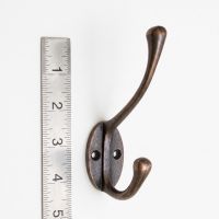 The 110mm Victorian Hat and Coat Hook in Antique Copper On a White Background  next to a Ruler for Scale - Digital Illustration