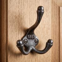 The 1883 Victorian Triple Prong Cast Iron Coat Hook Displayed Mounted on a Wooden Door - Digital Illustration