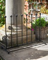 The 4-Pair Welly Boot Rack Stand Shown on a Stone Front House Entrance