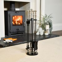 The 65cm Traditional Iron Companion Set With Brushed Chrome Handles in a Modern Interior Setting next to a Lit Hearth