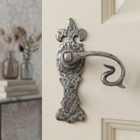 The Alvito Swan Neck Pewter Lever Latch Set on a Cream Door Shown Close Up