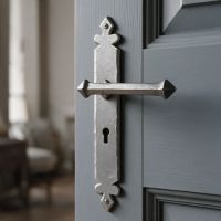 The Arundell Pewter Tudor Lever Lock on a Light Grey Door Leading to a Living Room - Digital Illustration