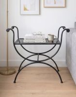 The Athens Single Stool, Or Butler Tray Table in Black Shown in a Modern Bedroom with a Cup and Books on it - Digital Illustration