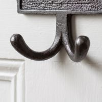 The Bathroom Plaque Double Robe Hook in Cast Antique Iron Showing a Close up of the Double Hook - Digital Illustration