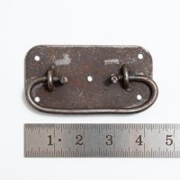 The Blacksmith Industrial Chest Drop Handle - 4" on a White Background next to a Steel Ruler for Scale - Digital Illustration