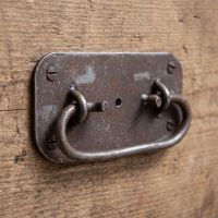 The Blacksmith Industrial Chest Drop Handle - 4" Shown on the Side of a Wooden Drawer - Digital Illustration