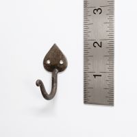 The Blacksmith Mini Spade Wall Hook - 50mm on a White Background next to a Steel Ruler for Scale - Digital Illustration
