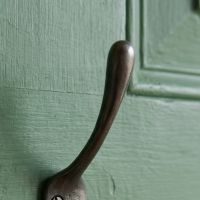The Blacksmith Vintage Cast Iron Three-Prong Hall Hook - 100mm Showing a Close up of the Upper Hook - Digital Illustration