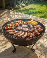 The Circular Kadai Grill Grate with Removable Centre Shown on a Sunny Garden Patio Used as a BBG - Digital Illustration