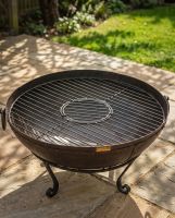 The Circular Kadai Grill Grate with Removable Centre Shown with Centre of Grill in Place on an Unlit Fire Bowl - Digital Illustration