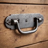 The Cotswold Backplate Drop Handle Shown Mounted on a Wooden Drawer - Digital Illustration