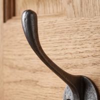 The Cotswold Circular Backplate Cast Iron Coat Hook 110mm Showing a Close uP View of the Upper Hook - Digital Illustration