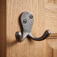 The Cotswold Double Ball-Tip Cast Iron Hook Displayed Mounted on a Wooden Clad Wall - Digital Illustration