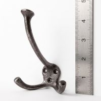 The Cotswold Flared Tip Triple Prong Wall Hook - 125mm on a White Background next to a Steel Ruler for Scale - Digital Illustration