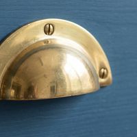 The Cotswold Round Lipped Cup Pull Handle in Brass Showing a Close up of the Grip - Digital Illustration