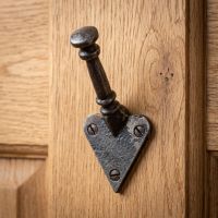 The Craftsman Minimalist Cast Iron Hook - 100mm Shown Mounted on a Timber Door - Digital Illustration