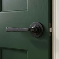 The Dickinson House Beeswax Unsprung Lever Door Handle on Rose Shown on a Dark Green in a Country Home - Digital Illustration