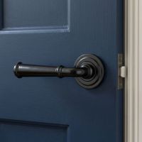 The Edlyn House Midnight Black Unsprung Lever Door Handle on Art Deco Rose in a Modern Interior Setting Mounted on a Door - Digital Illustration
