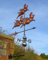 The Flight of Flying Pigs Verdigris Copper Weathervane Shown From a Low Angle Mounted on a Building