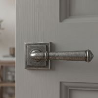 The Hadley Gardens Antique Pewter Unsprung Lever Door Handle on Square Rose on a Charcoal Coloured Door in a Modern Home - Digital Illustration