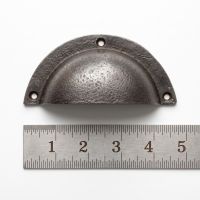 The Half-Moon Cast Antique Iron Cup Pull Handle - 110mm on a White Background next to a Steel Ruler for Scale - Digital Illustration