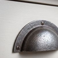 The Half-Moon Cast Antique Iron Cup Pull Handle - 110mm Showing a Close up of the Rounded Backplate - Digital Illustration