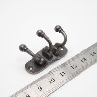 The Hawthorn Triple Coat Hook in Cast Antique Iron - 35 x 90mm On a White Background  with a Ruler - Digital Illustration