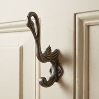 The Heron Cast Antique Iron Hat and Coat Hook Shown on the Back of a White Door - Digital Illustration