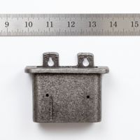 The Inn Cast Iron Bottle Cap Catcher on a White Background next to a Ruler for Scale