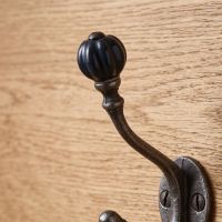 The Ironmonger Acorn Dark Green Ceramic Coat Hook - 125mm Showing a Close up of the Rounded Ceramic Hook - Digital Illustration