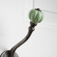 The Ironmonger Acorn Light Green Ceramic Coat Hook - 125mm Showing a Close up of the Ceramic Rounded Finial - Digital Illustration