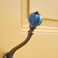 The Ironmonger Acorn Sky Blue Ceramic Coat Hook - 125mm Showing a Close up of the Ceramic Finial - Digital Illustration