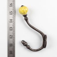 The Ironmonger Acorn Yellow Ceramic Coat Hook - 125mm On a White Background  with Ruler for Scale - Digital Illustration