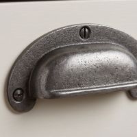 The Ironmonger Crescent Cup Pull 47mm x 102mm Showing a Close up of the Screw Attachments - Digital Illustration