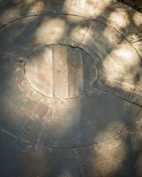 The Kadai Fire Bowl Shield and Snuffer Lid Showing a Close up of the Panel Design Lid - Digital Illustration