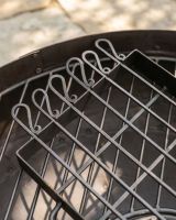 The Kadai Hand-Forged 6-Piece Skewer Set with Elevated Rack Showing a Close up of the Skewers and Frame on top of a Firepit - Digital Illustration