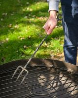 The Kadai Hand-Forged Iron Cooking Fork with Ring Handle Being Held over a Kadai bowl and Grill - Digital Illustration