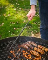 The Kadai Hand-Forged Iron Cooking Fork with Ring Handle Being Used whilst Cooking Food over a Grill - Digital Illustration