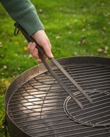 The Kadai Hand-Forged Iron Cooking Tongs with Ring Handle Shown Next to a Kadai Bowl and Grill - Digital Illustration
