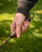 The Kadai Marshmallow Roasting Branch with Wooden Handle Showing a Hand Gripping the Wooden Handle - Digital Illustration