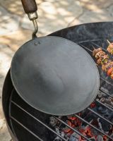 The Kadai Tawa Flat Iron Cooking Pan with Wooden Handle Shown over a Kadai Fire Pit - Digital Illustration